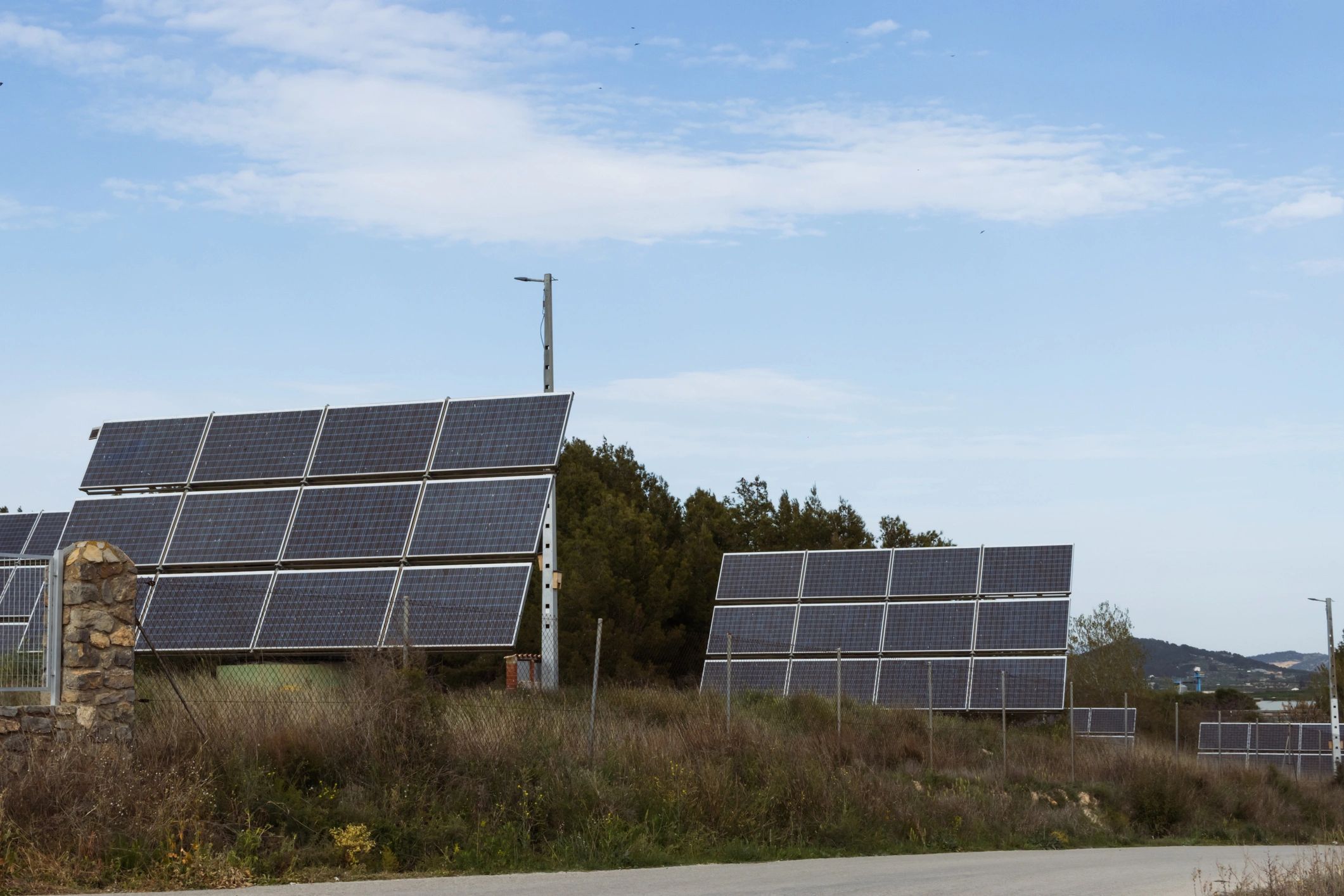 Array of modern solar panels generating clean renewable energy, contributing to sustainability, ecology, and environmental preservation under a clear blue sky